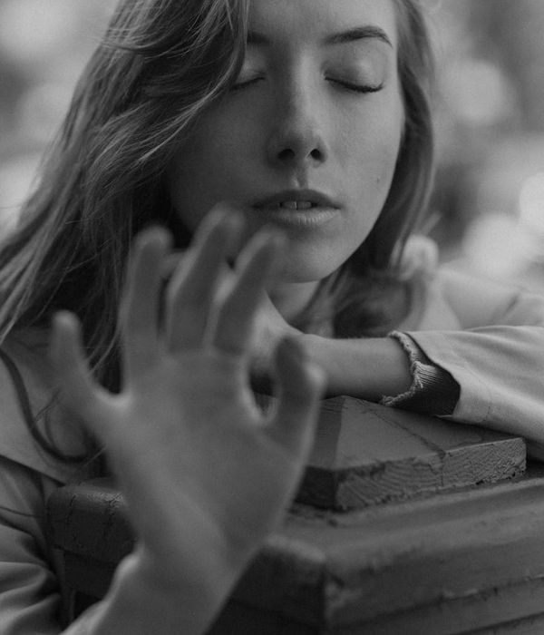 Person in a state of calm concentration during a gentle exercise, with soft focus background.